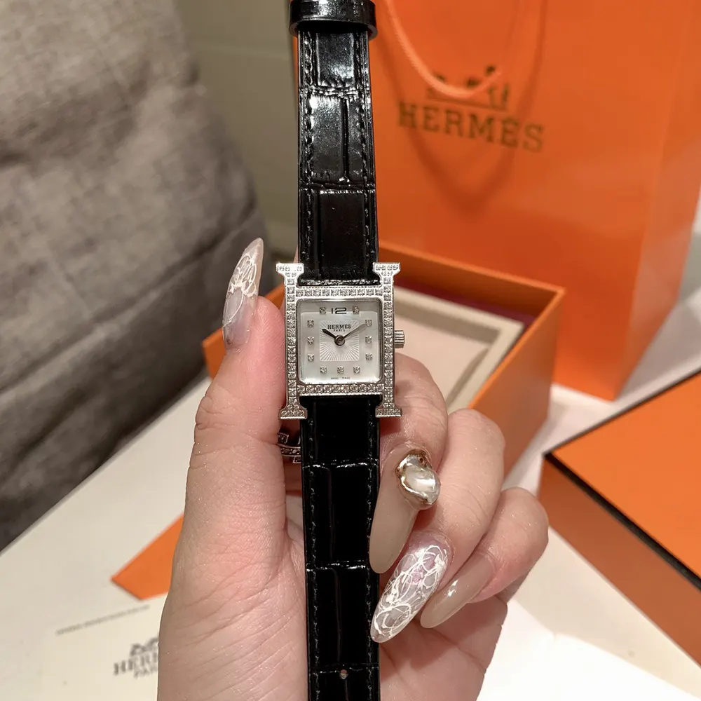 Close-up of silver H-shaped case detail on Hermes Women Heure H Watch Small Model