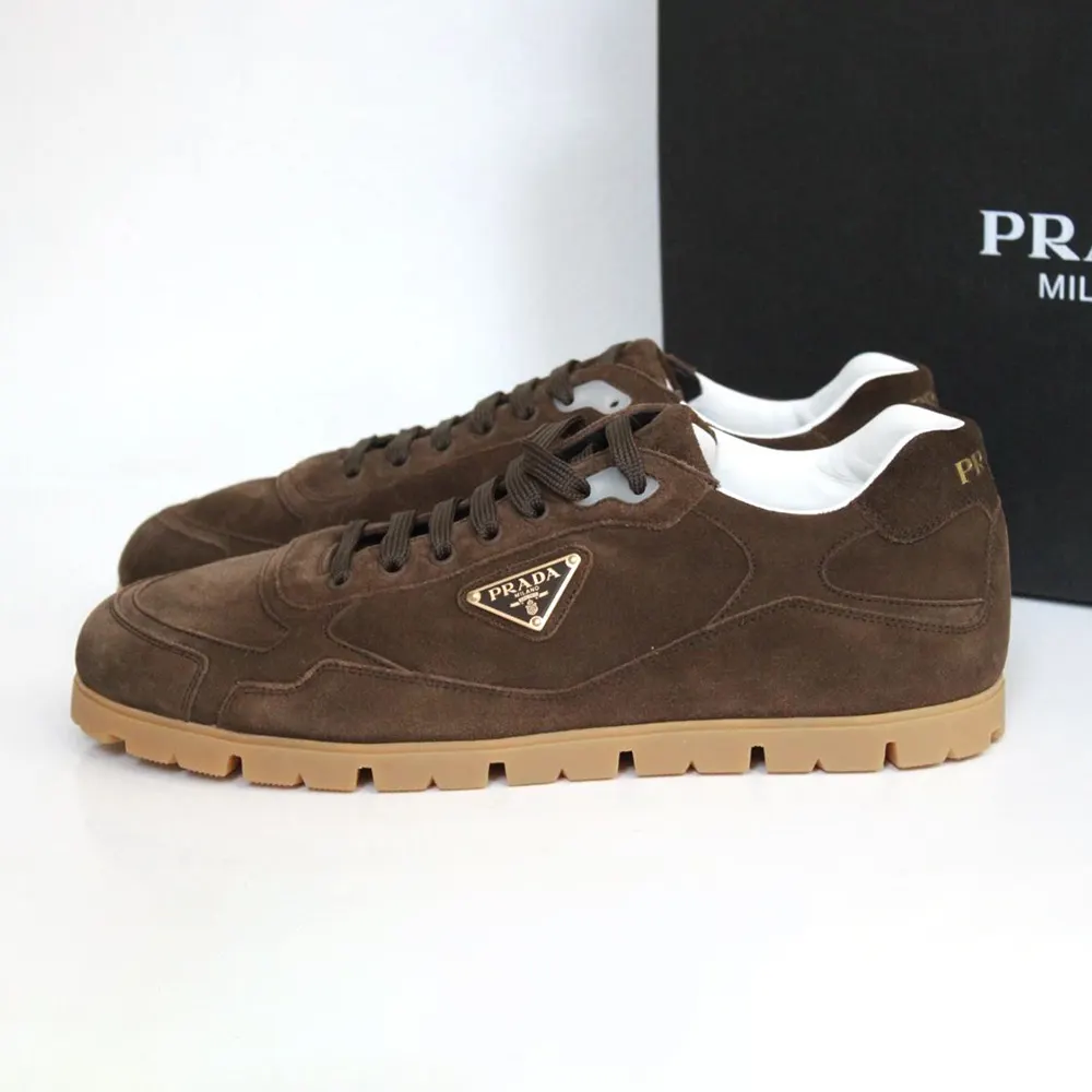 Close-up on brown suede and Prada logo embossed detail sneaker