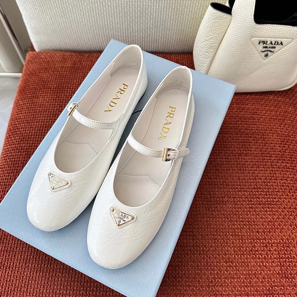 Close-up detail of glossy white patent leather on Prada Women Naplak Patent Leather Ballerinas-White