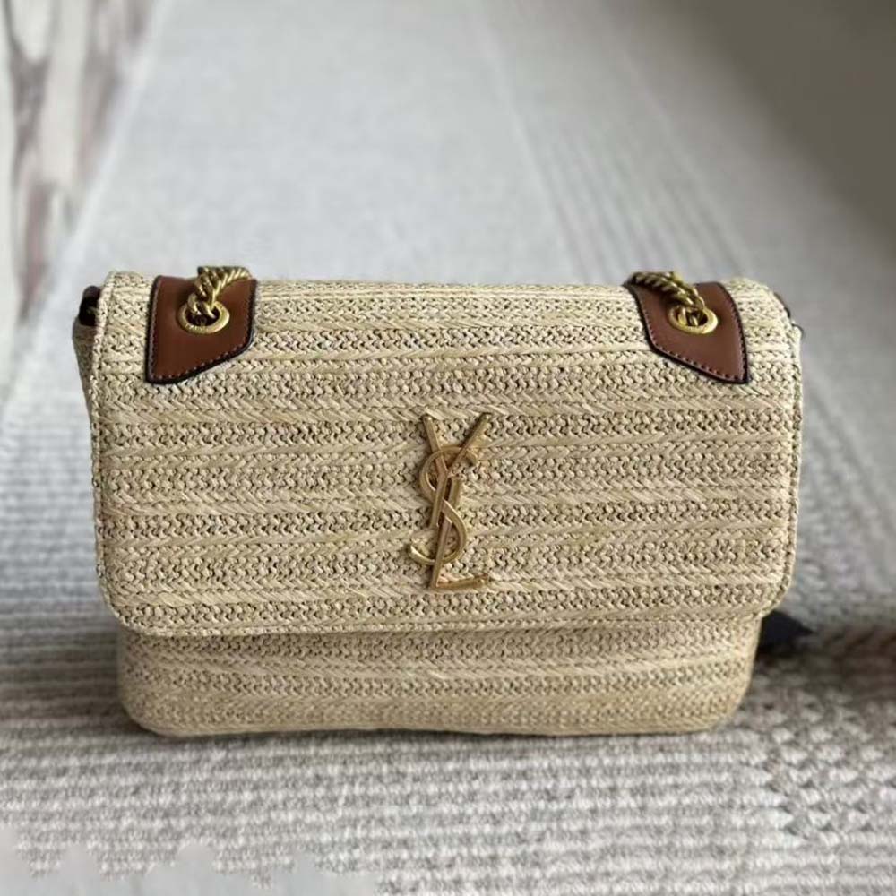 Close-up of gold YSL chain hardware on natural raffia Niki Medium bag
