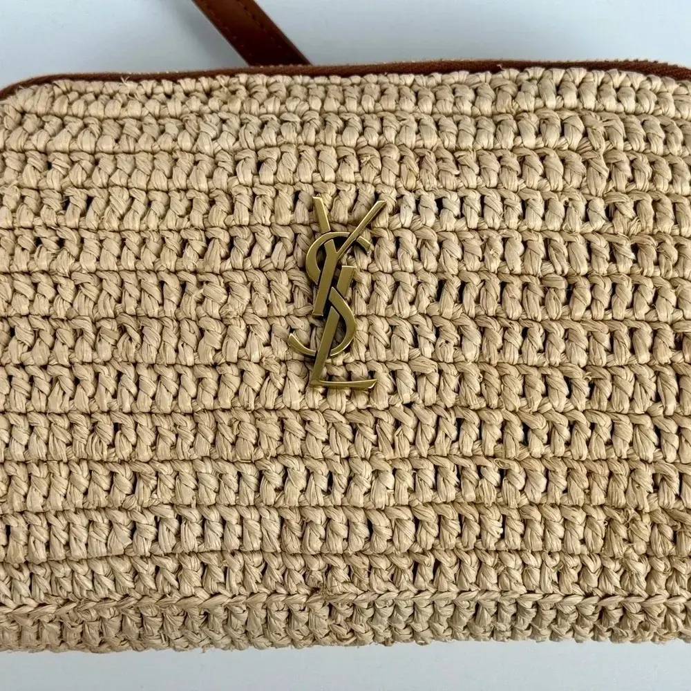 Side angle showing texture and zipper detail on Saint Laurent YSL pouch