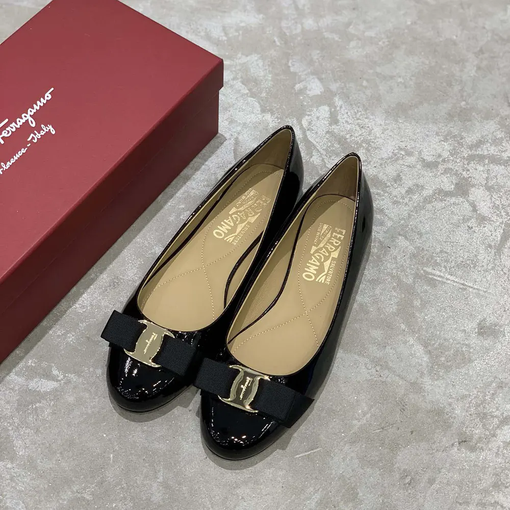 Close-up of grosgrain bow and gold logo detail on Varina Ballet Flat-Black