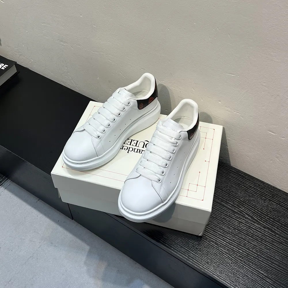 Close-up on red accent and signature chunky sole of Alexander Mcqueen Unisex Oversized Sneaker