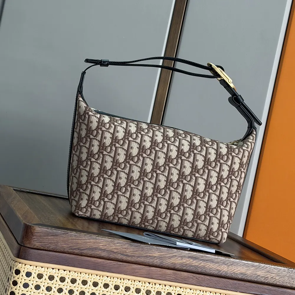 Side profile showing slim silhouette of Dior Men Jett Pouch Brown