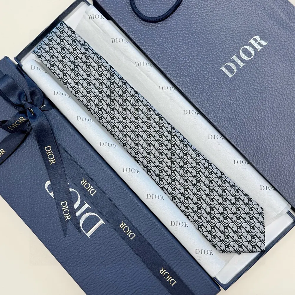 Close-up of woven Dior oblique detail on gray silk tie