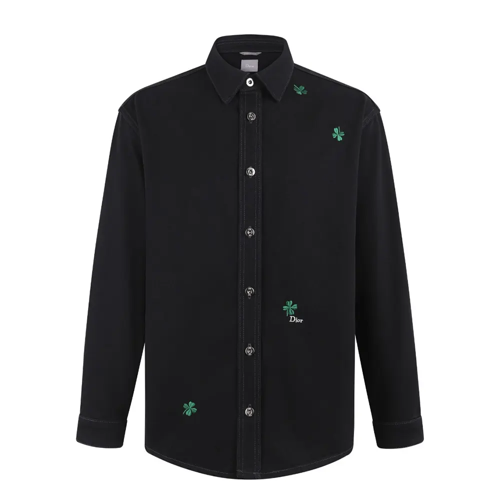 Close-up of Dior Clover embroidery detail on black cotton twill overshirt