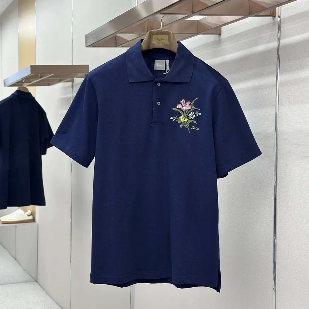 Close-up detail of blue cotton piqué fabric and embroidery on Dior polo