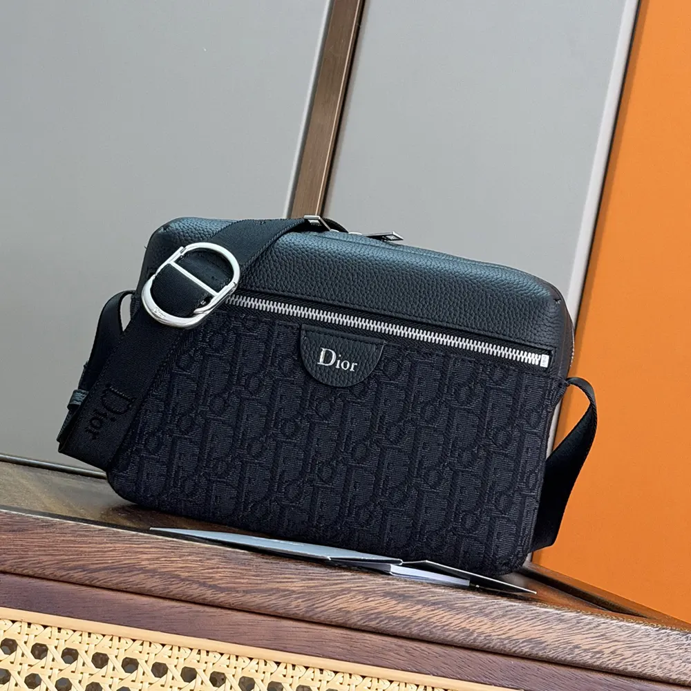 Close-up of black grained calfskin and gunmetal zipper on Dior Men Rider Zipped Messenger Bag
