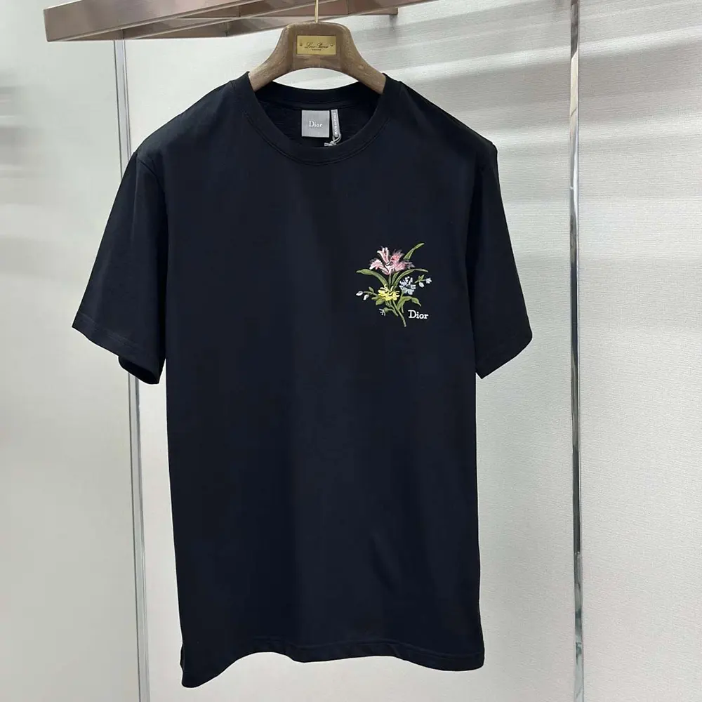 Close-up of black cotton jersey and garden motif detail on Dior t-shirt