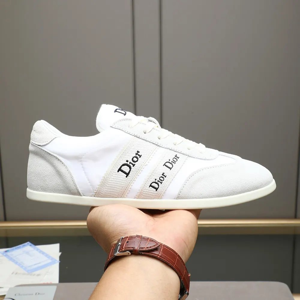 Close-up of Dior ribbon detail on white suede sneaker