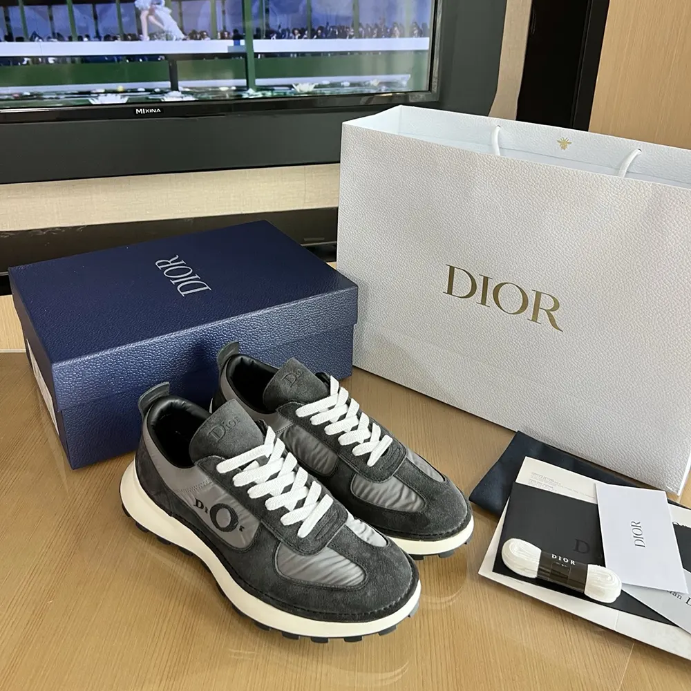 Close-up on Dior metal logo detail of the Dior Unisex Squash Sneaker