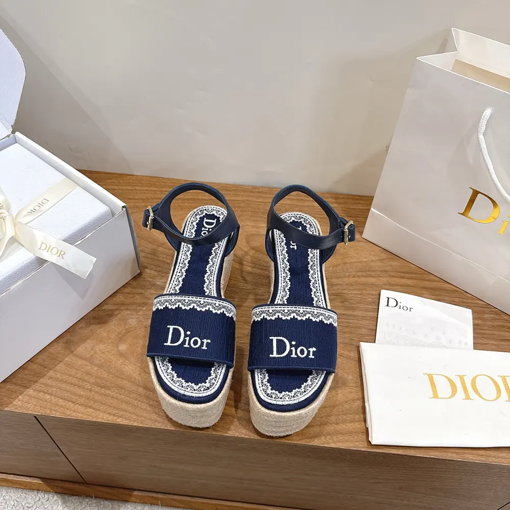 Close-up detail of white lace and embroidered cotton on Dior Women Dentelle Wedge Sandal