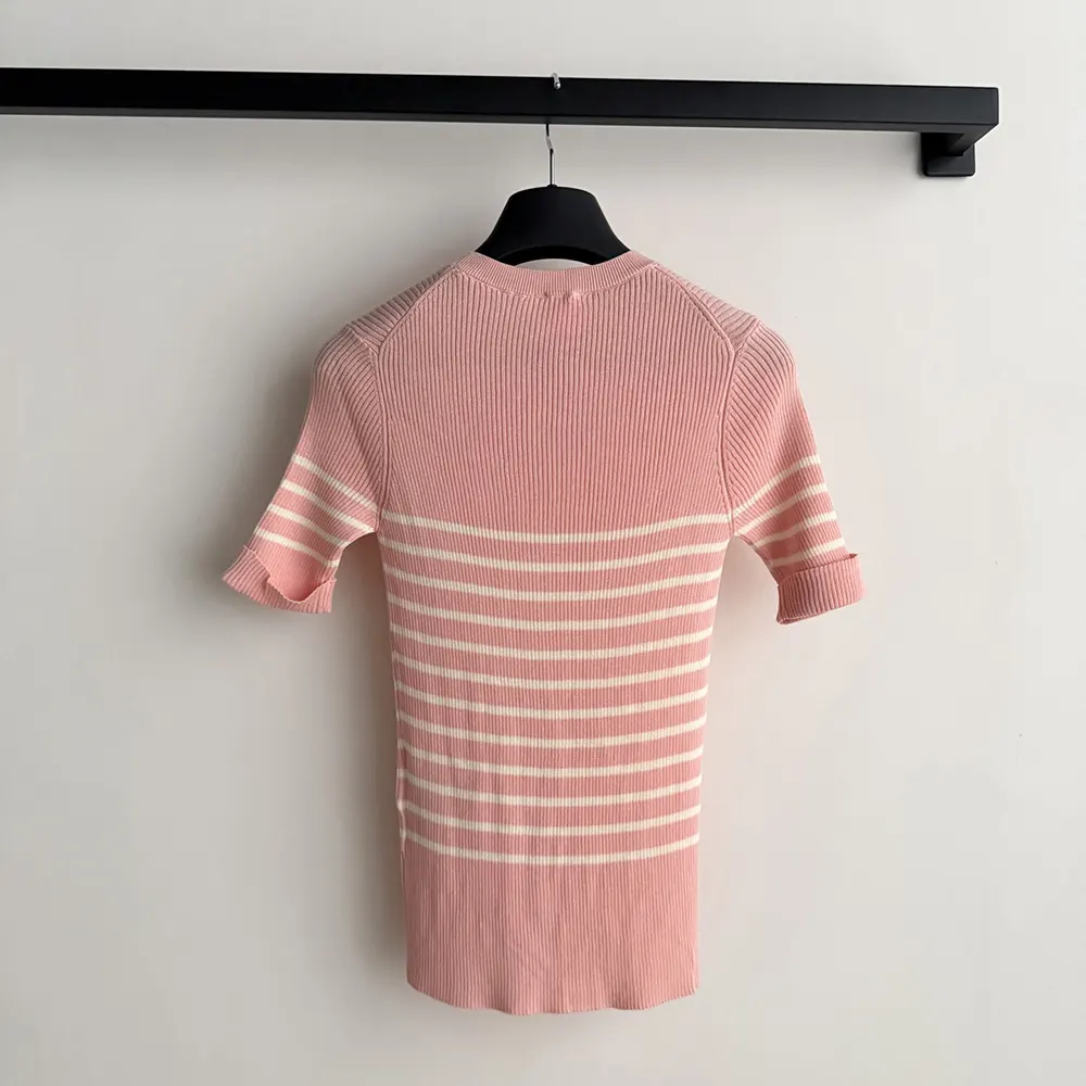 Side angle showing fit and sleeve details of Dioriviera sweater