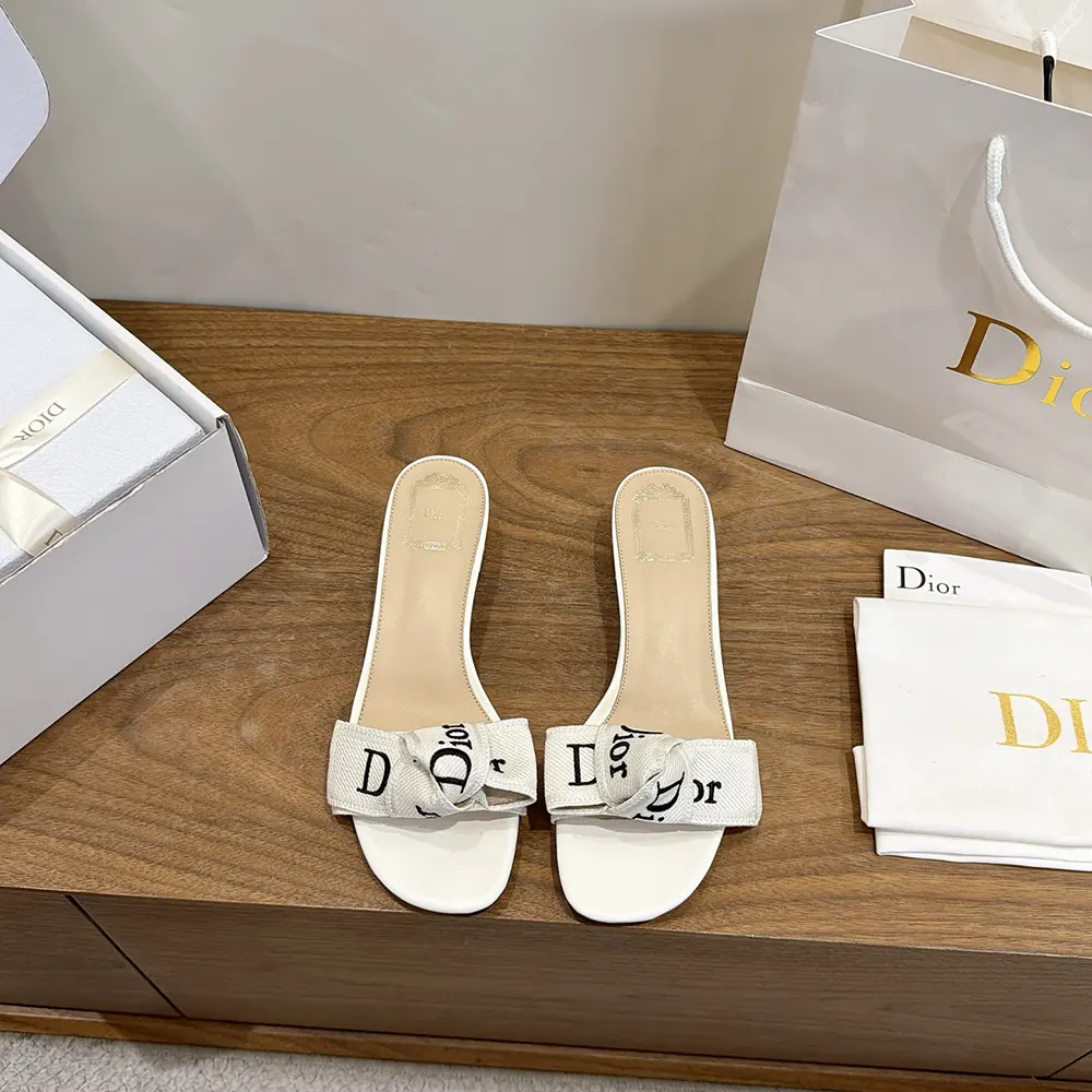 Close-up of gold-tone J’Adior hardware on ivory embroidered slide