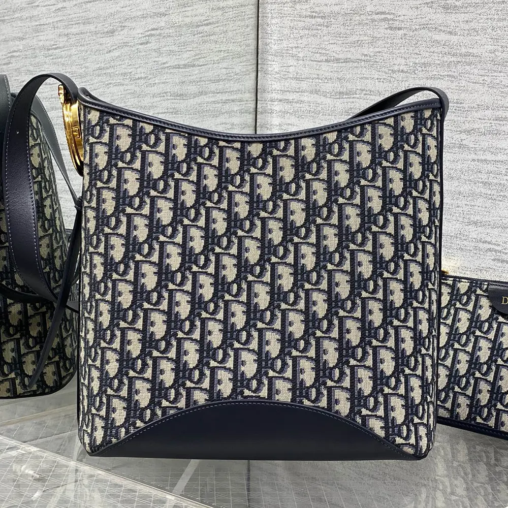 Side angle showing blue jacquard fabric texture on Dior Women Medium Dior Médaillon Bucket Bag