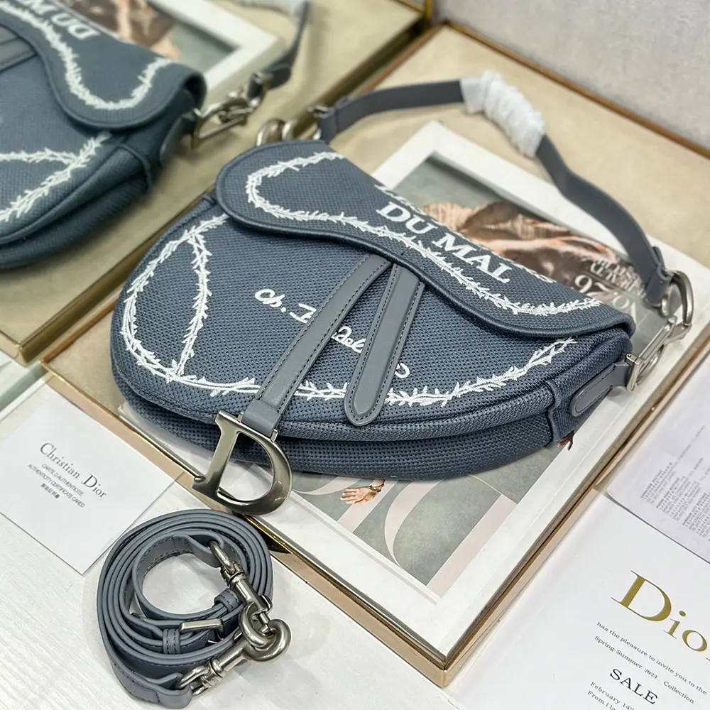 Side angle showing Dior Women Saddle Bag with adjustable shoulder strap and silver hardware