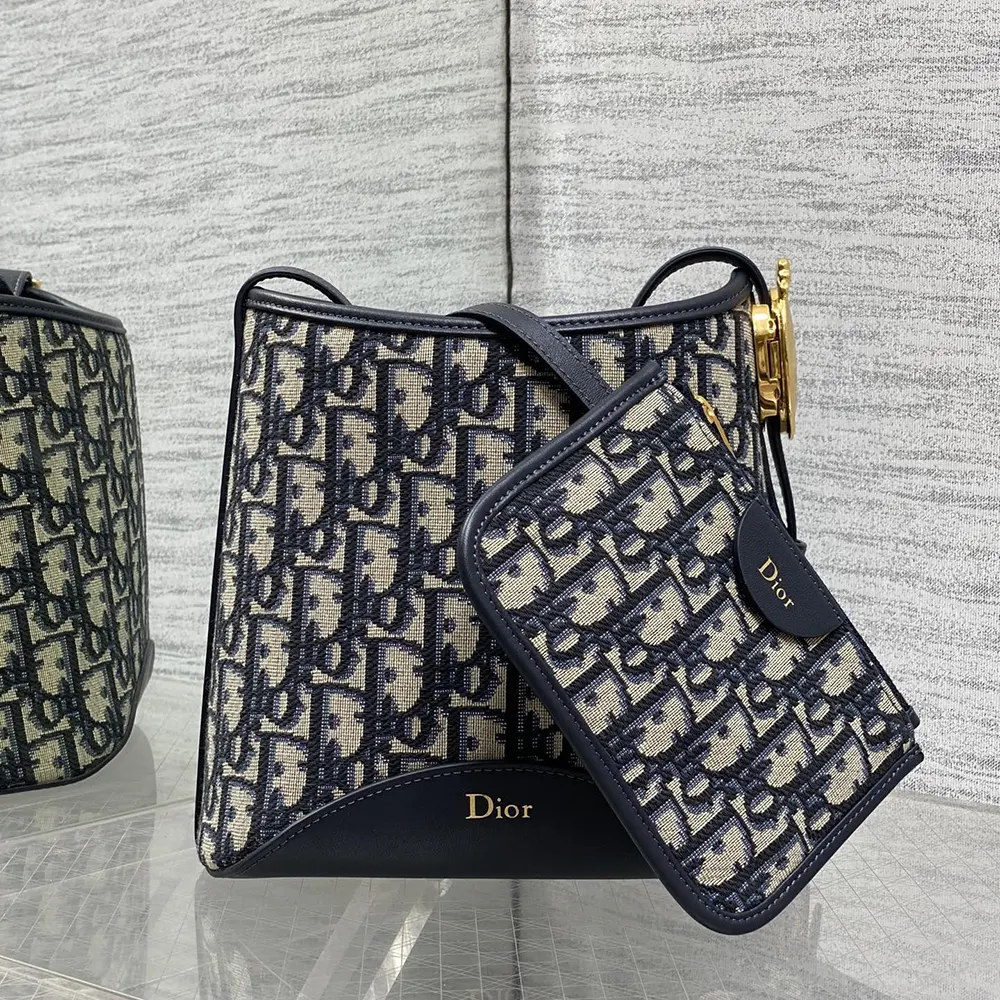 Close-up of signature Médaillon charm on Dior Women Small Dior Médaillon Bucket Bag