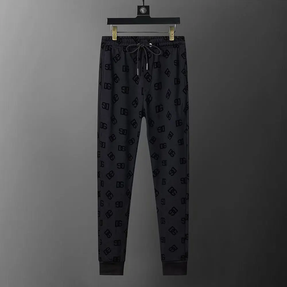 Close-up detail of flocked DG logo on black Dolce Gabbana jogging pants