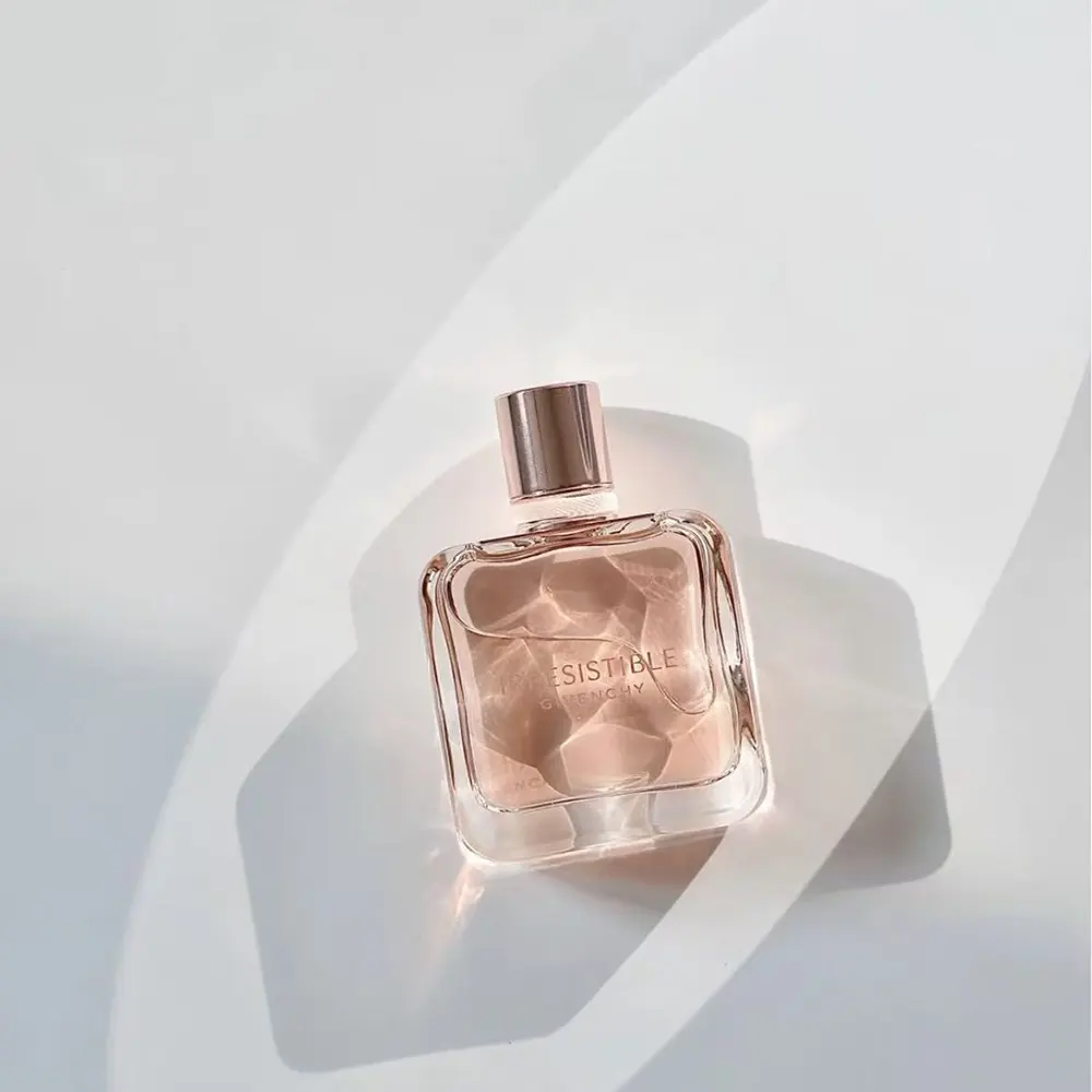 Side angle showing pink glass and silver cap of Givenchy Irresistible