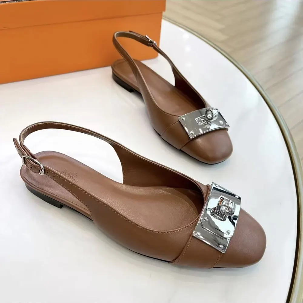Close-up of gold Kelly buckle on Hermes Women Gold Innocente Slingback