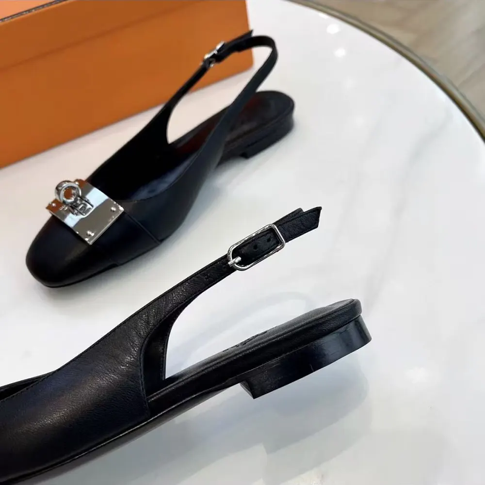 Overhead view showcasing black leather and elegant silhouette of Hermes Women Gold Innocente Slingback
