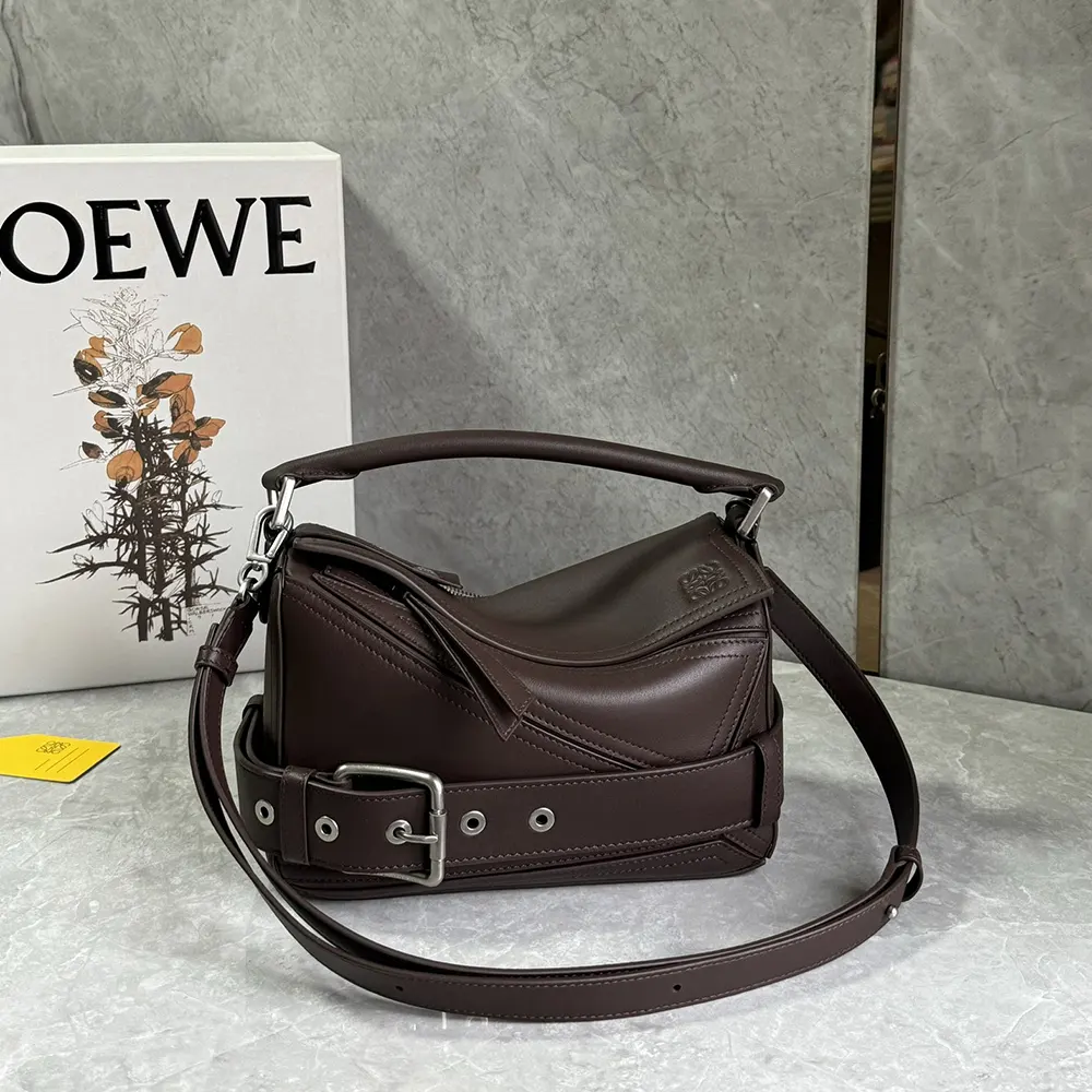 Side angle showing adjustable strap and geometric shape of Loewe Puzzle Biker Bag