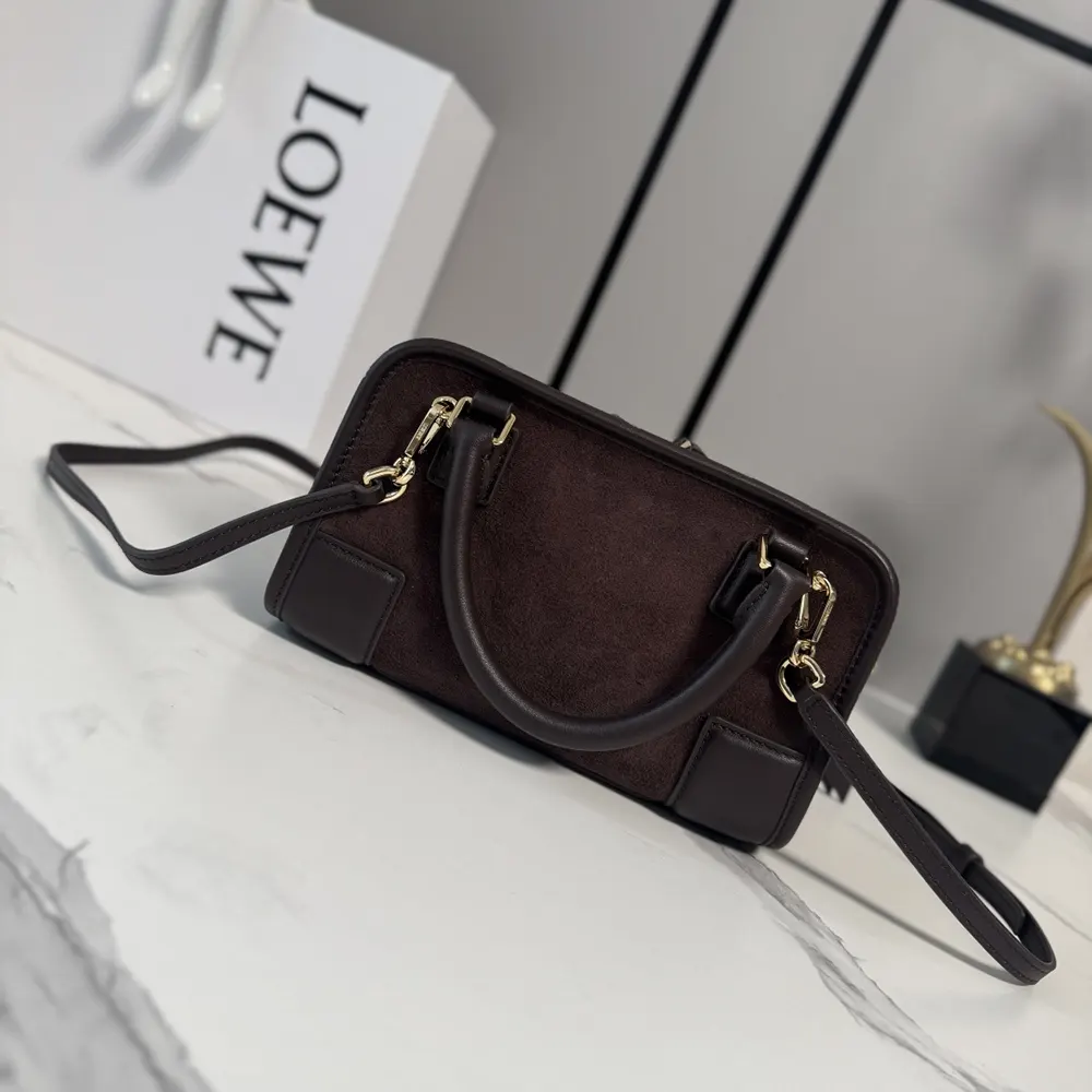 Side angle showing leather shoulder strap and flap closure on Mini Amazona 180 Bag