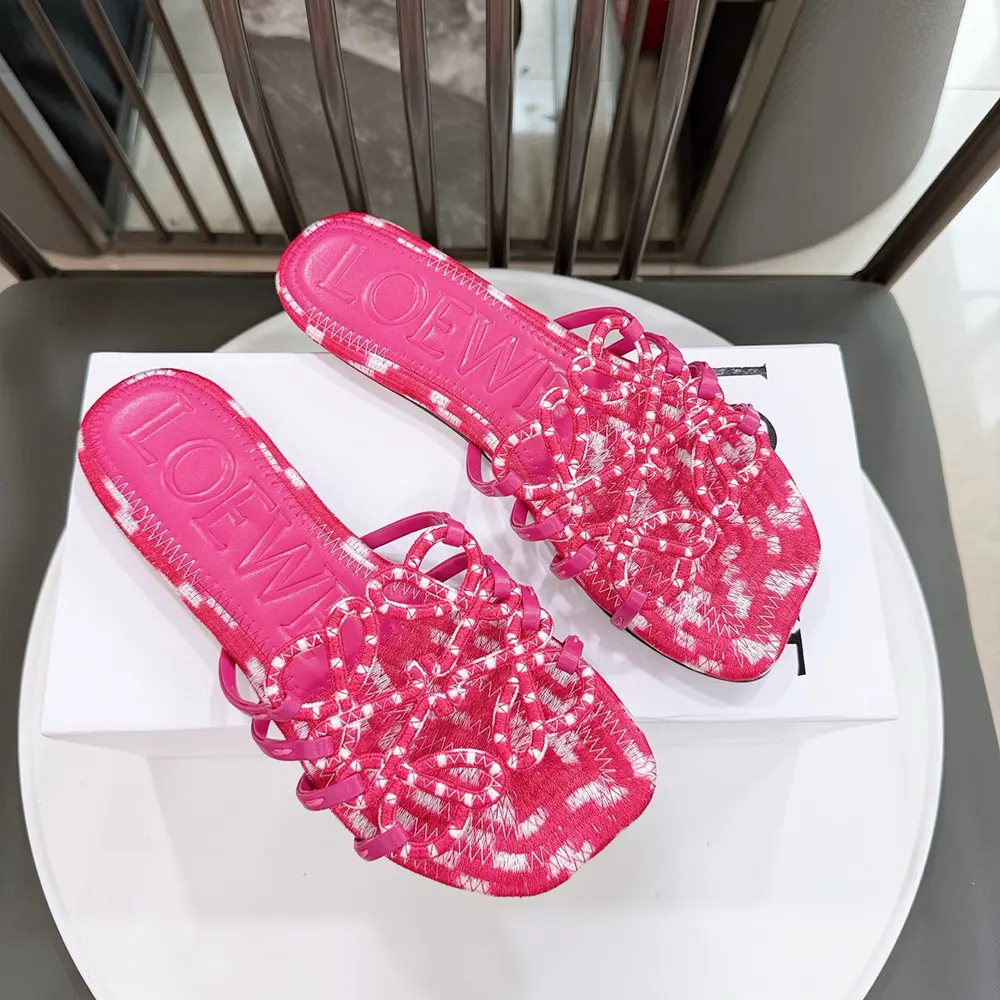 Top view showing pink canvas and slip-on design of Loewe Women Petal Anagram Slide