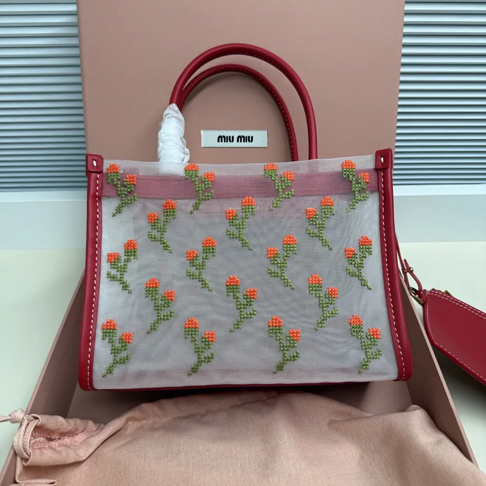 Side angle showing gold hardware on Miu Miu Women Embroidered Mesh Top-handle Bag-Red