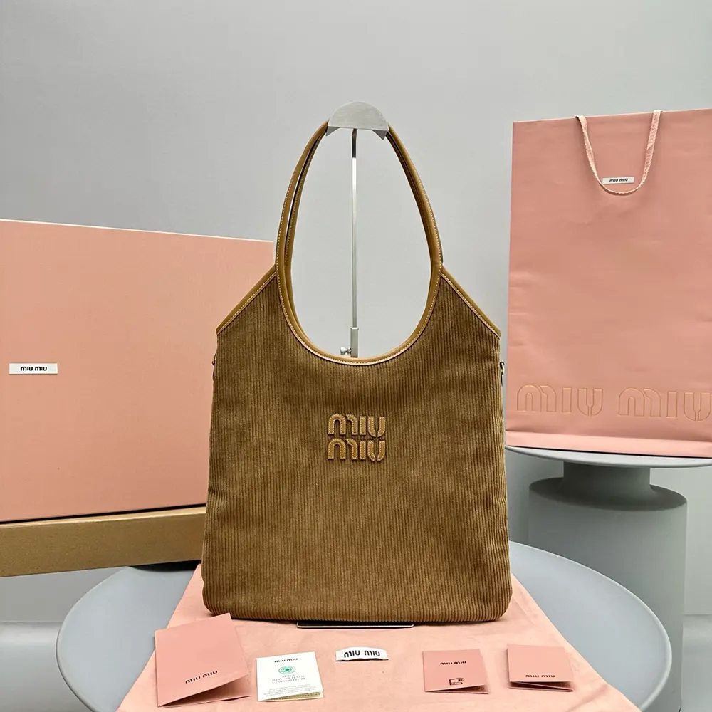 Close-up of brown corduroy texture and leather logo on Miu Miu bag