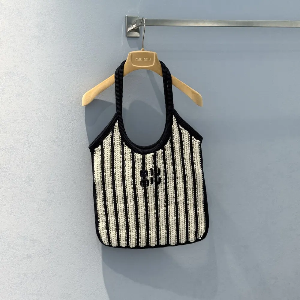 Side angle showing silhouette and leather trim of Miu Miu Women Ivy Crochet Bag