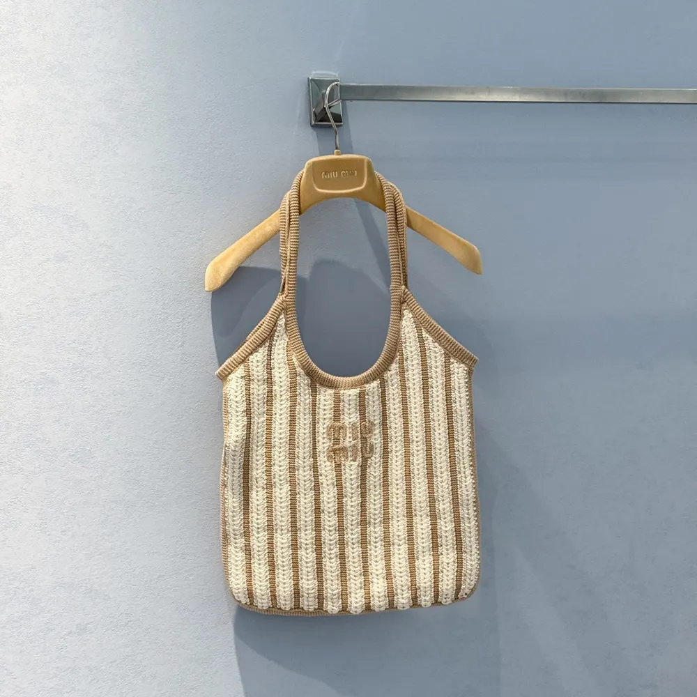 Side angle showing leather trim and open-knit detail on Miu Miu bag