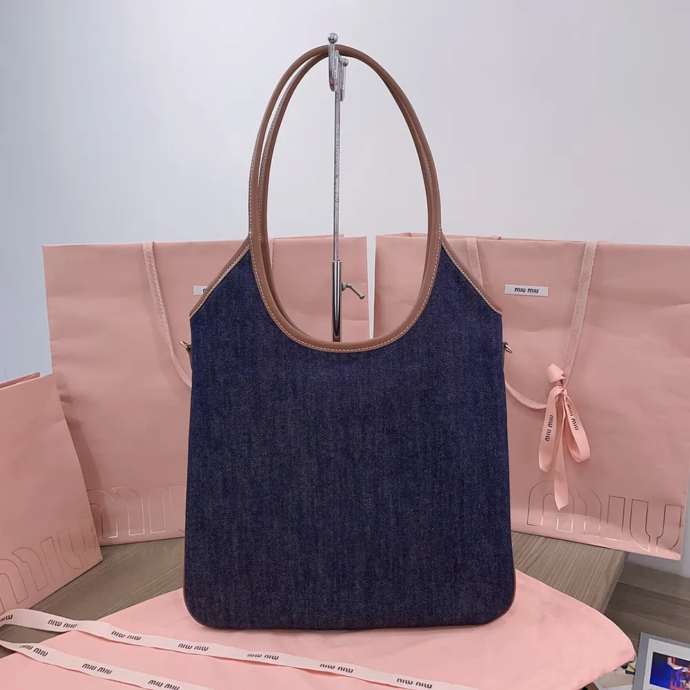 Side angle showing adjustable shoulder strap of Miu Miu Women Ivy Denim Bag