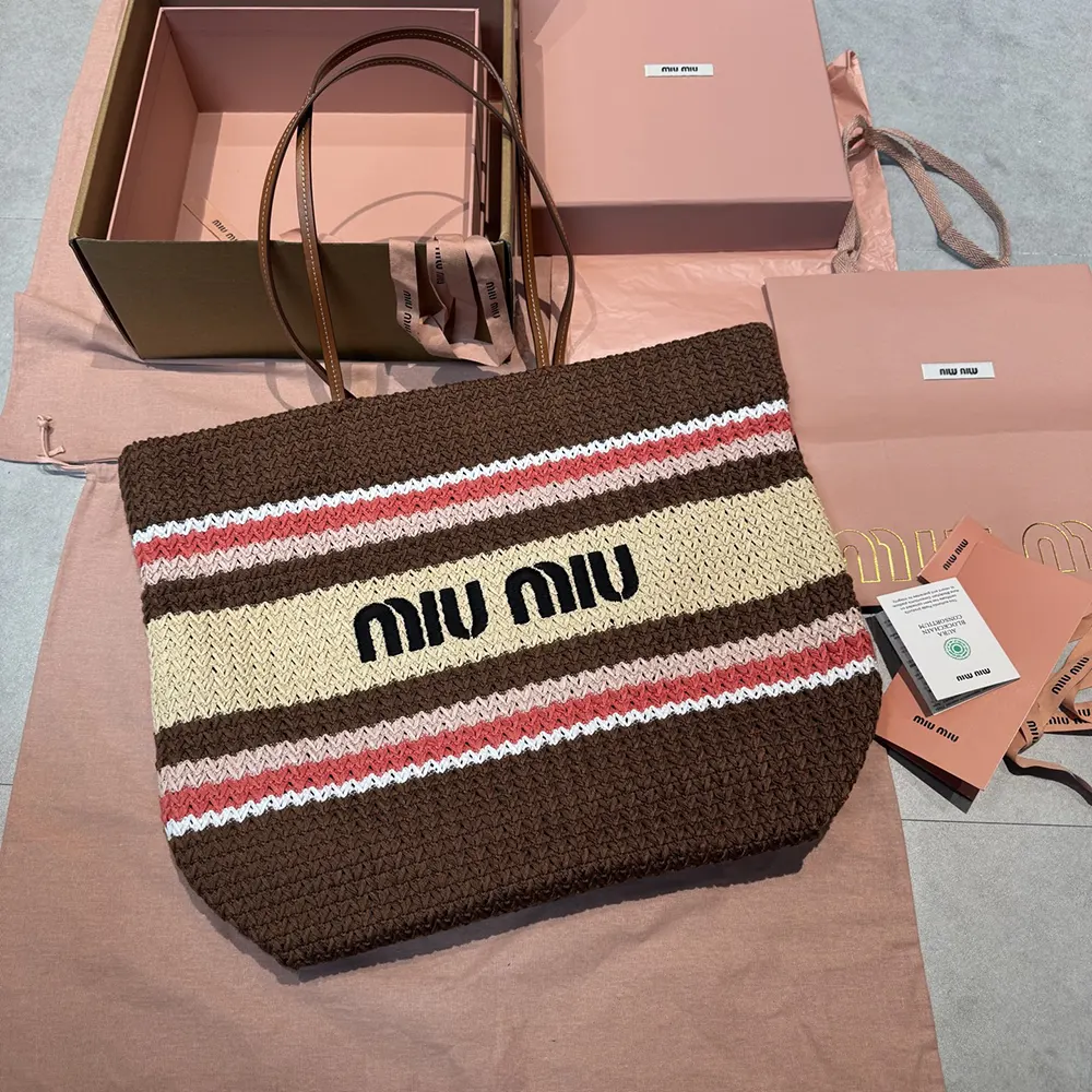 Close-up detail of gold-tone hardware on woven Miu Miu tote bag