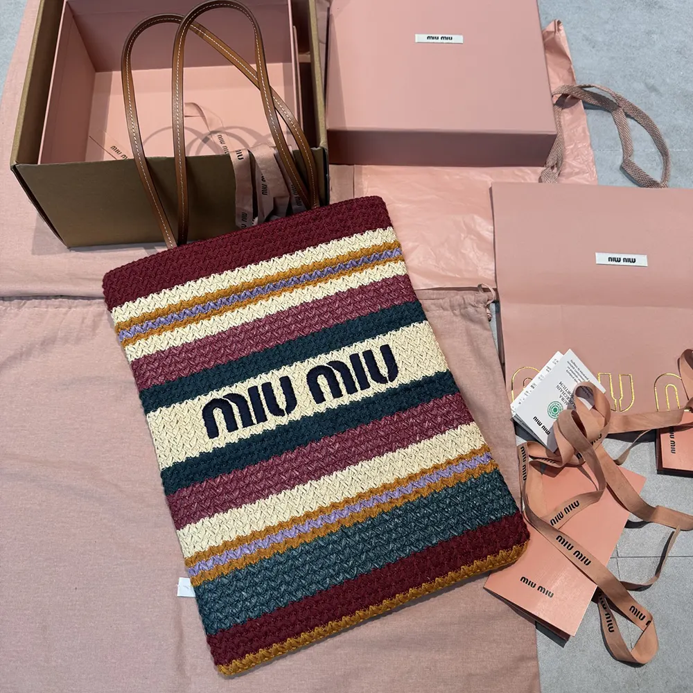 Close-up of woven raffia-effect texture and gold hardware on Miu Miu tote