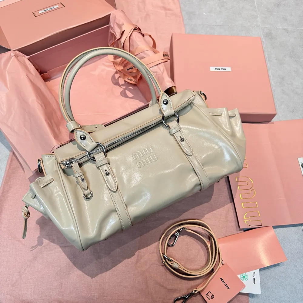 Close-up of gold-tone hardware on Miu Miu Women Shiny Leather Handbag-Light Pink