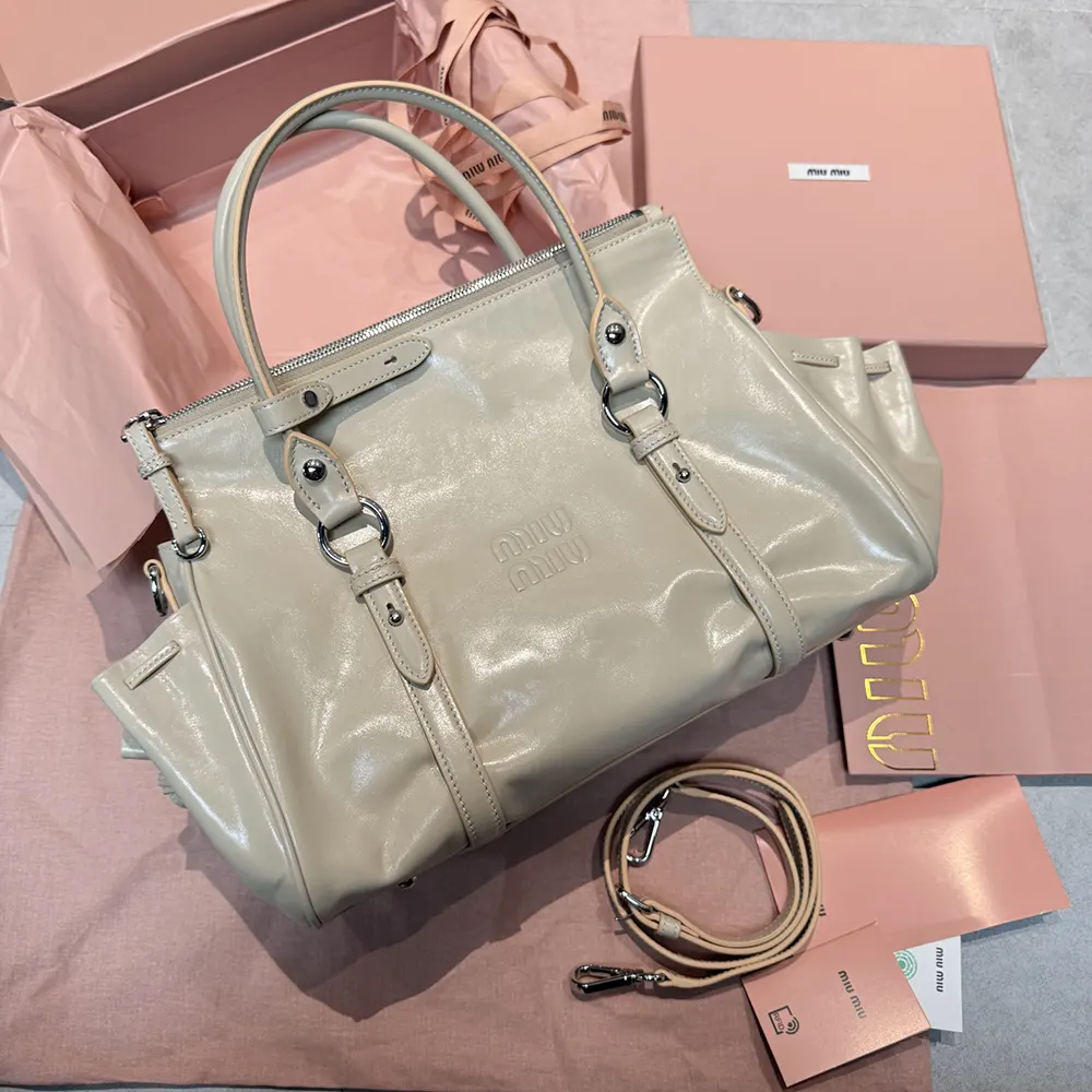 Side angle of Miu Miu Women Shiny Leather Handbag-Light Pink highlighting silhouette