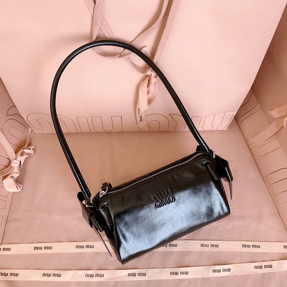 Close-up of silver-tone zipper and hardware on Miu Miu Women Shiny Leather Pouch-Black