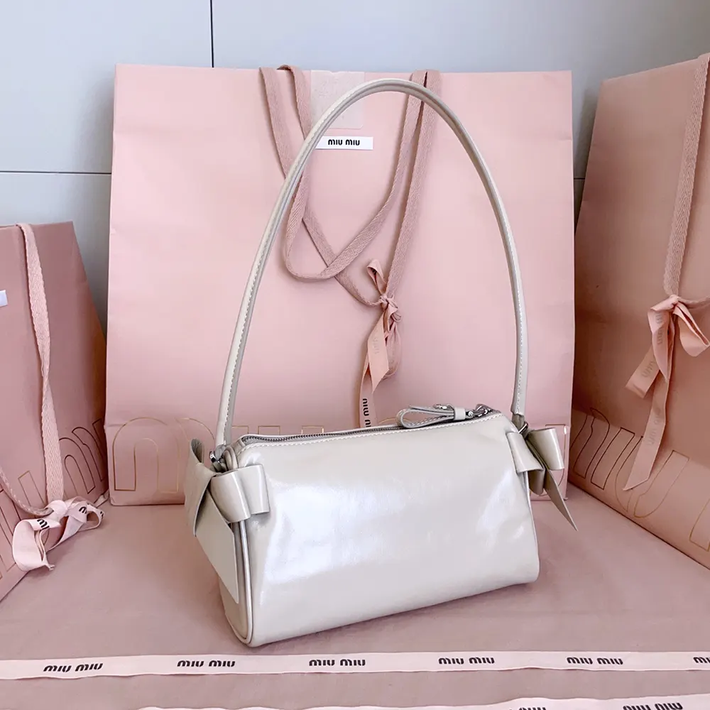 Side profile showing compact silhouette of Miu Miu Women Shiny Leather Pouch-Pink
