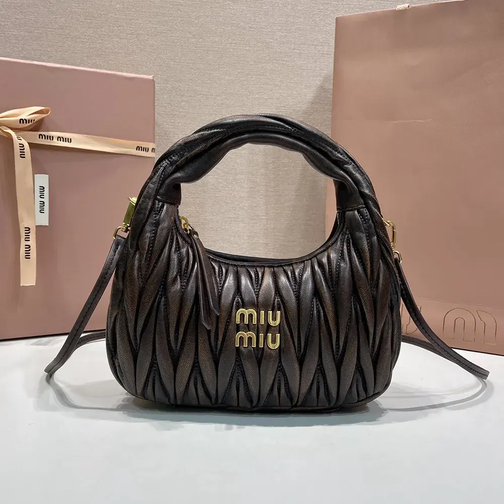 Close-up of matelassé quilting and gold hardware on Miu Miu bag