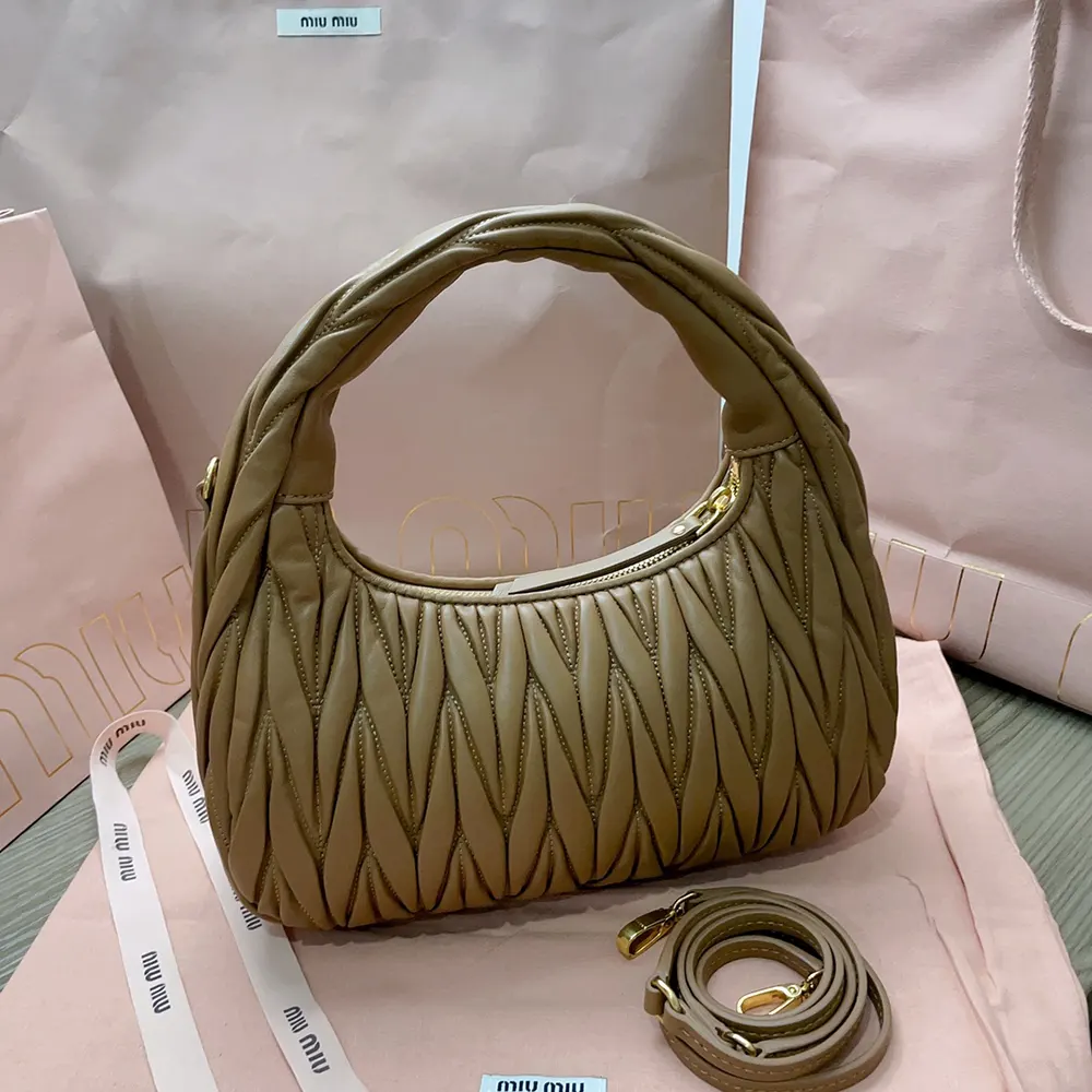Side angle showing gold-tone hardware and shape of Miu Miu Women Wander bag