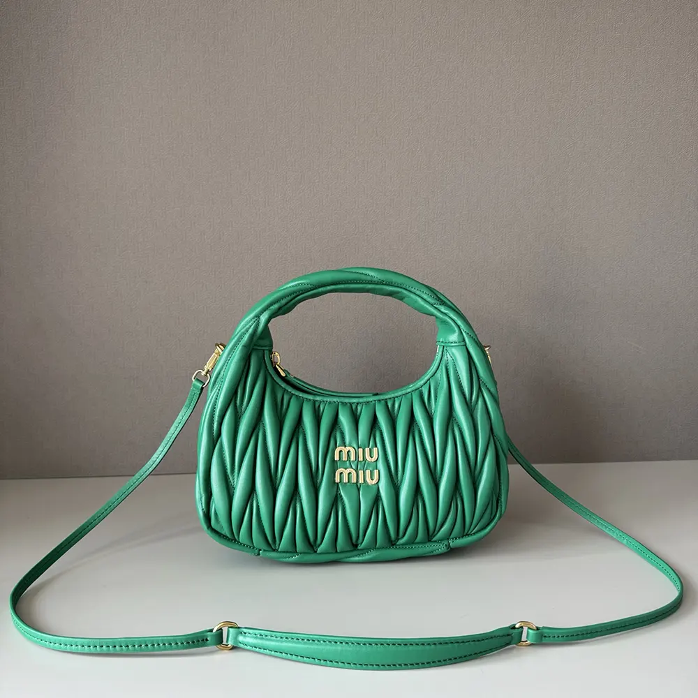 Close-up of matelassé quilting and silver hardware on the Miu Miu bag