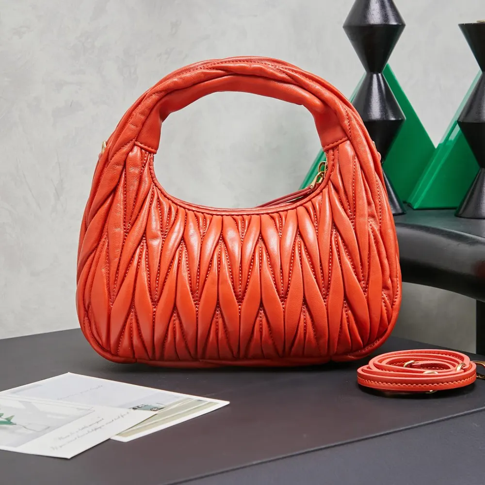 Side angle showing silver hardware on Miu Miu Women Wander Hobo Bag-Orange