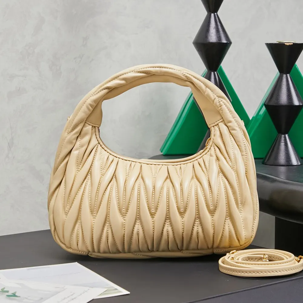 Front view showing magnetic closure and antique gold hardware on Miu Miu Women Wander Bag