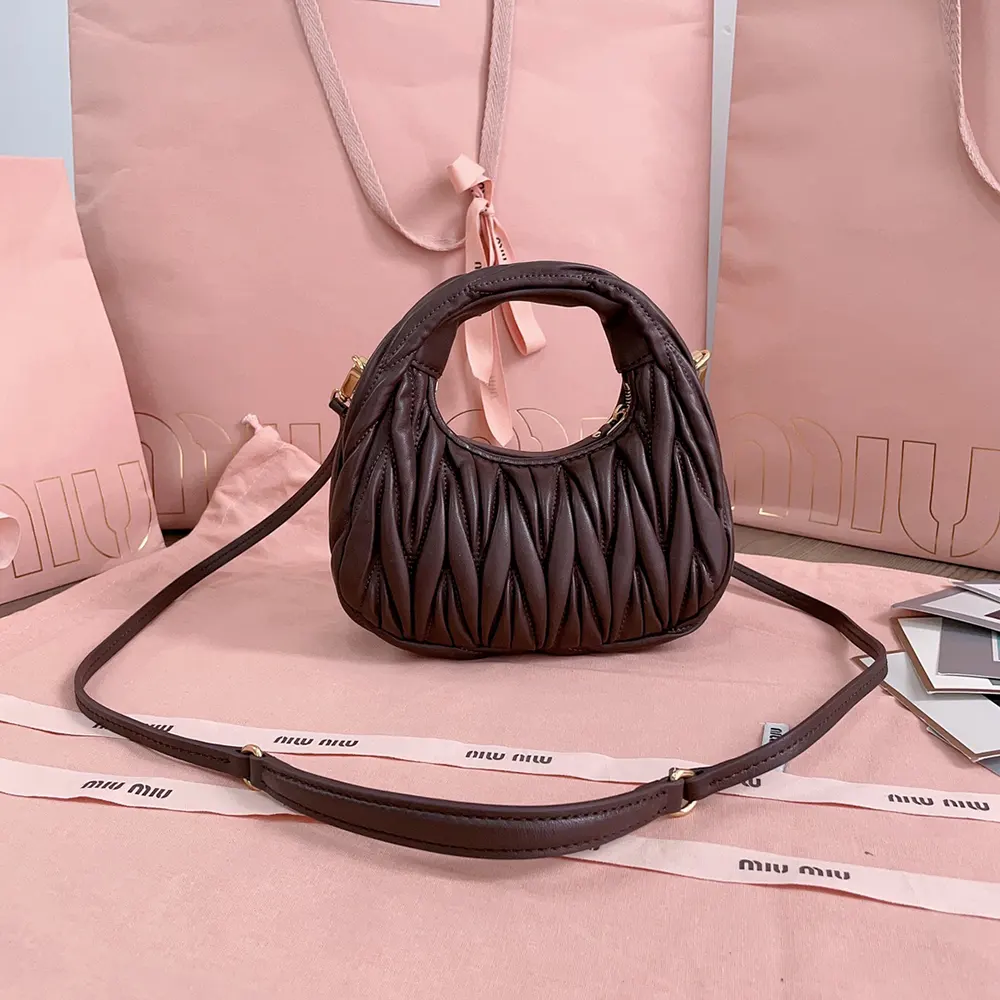 Side angle showing compact silhouette of Miu Miu Women Wander Matelassé Nappa Leather Hobo Mini-Bag-Burgundy