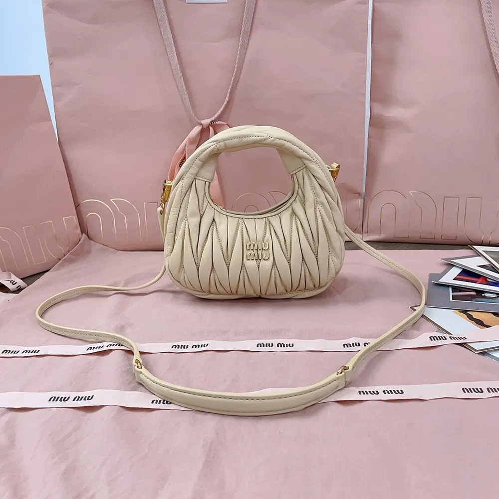 Close-up of matelassé quilting and gold hardware on Miu Miu mini-bag
