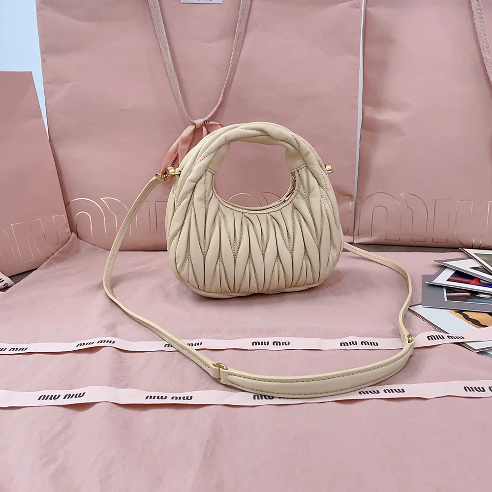Side angle showing compact shape of Miu Miu Women Wander Hobo Mini-Bag