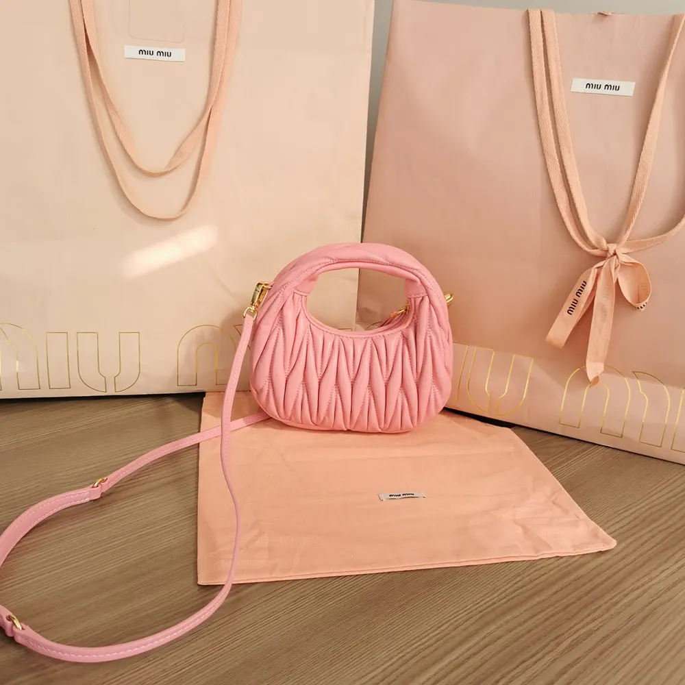 Close-up of matelassé quilting detail on pink Miu Miu mini-bag