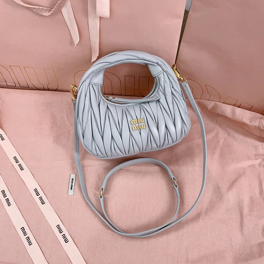 Close-up on matelassé quilting and silver hardware of Miu Miu mini-bag
