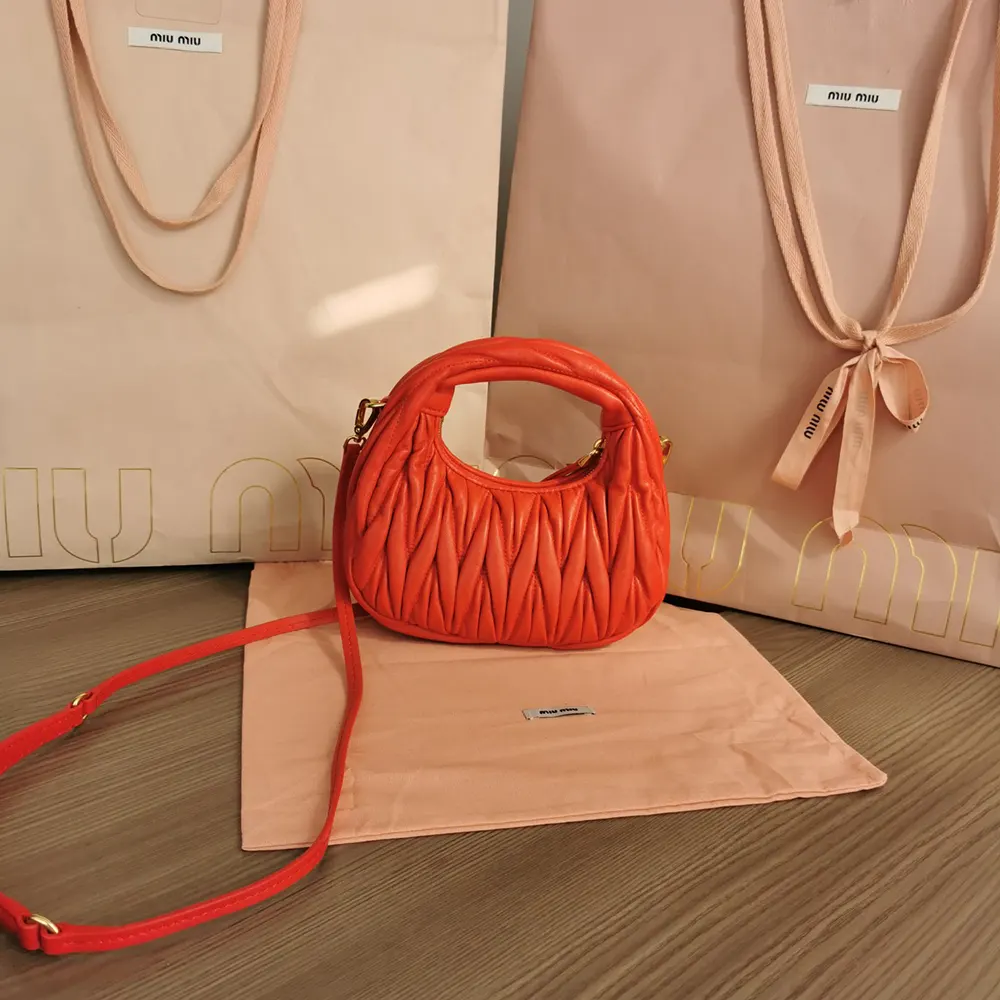 Side angle showing silhouette and strap of Miu Miu Women Wander Hobo Mini-Bag